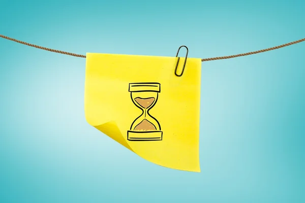 Hourglass on post-it with blue background — Stock Photo, Image