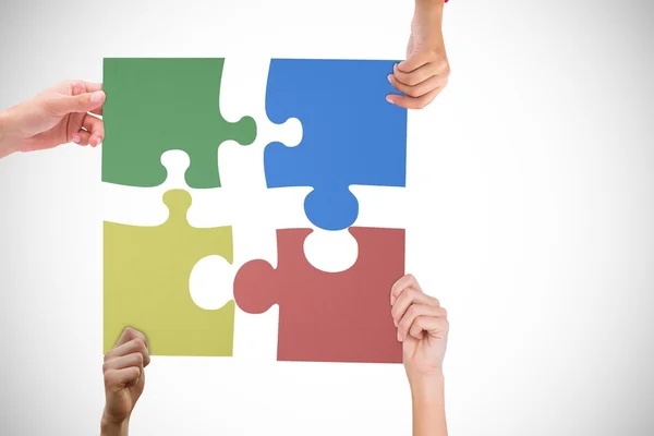 Hands holding jigsaw puzzles — Stock Photo, Image