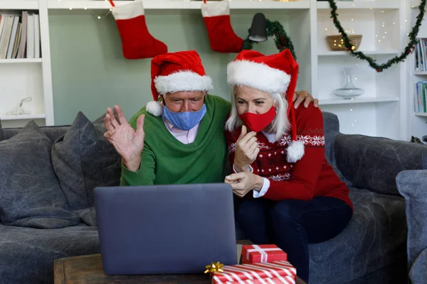 Ein Älteres Paar Mit Weihnachtsmannmützen Winkt Während Hause Ein Videotelefonat — Stockfoto