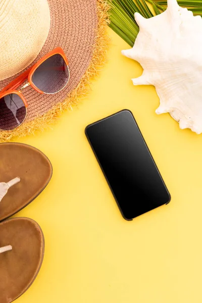 Sonnenbrille Flip Flops Sonnenhut Shell Und Smartphone Auf Gelbem Hintergrund — Stockfoto