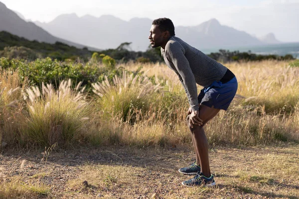 Ένας Ικανός Αφροαμερικάνος Αθλητικά Ακουμπά Στα Γόνατα Ψηλό Γρασίδι Υγιεινός — Φωτογραφία Αρχείου