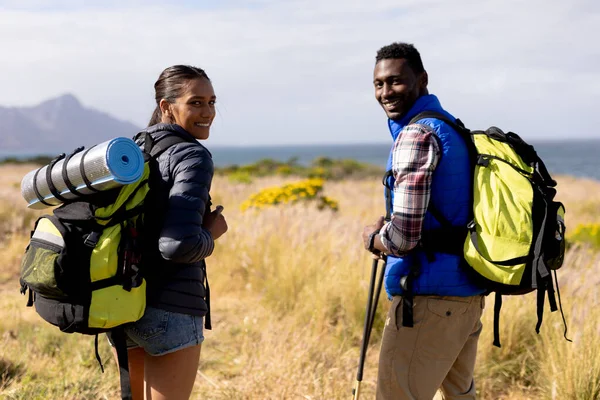Fit African American Couple Wearing Backpacks Nordic Walking Coast Looking — Stock fotografie