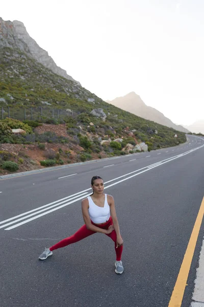 Fit African American Woman Sportswear Stretching Coastal Road Looking Camera — Stockfoto