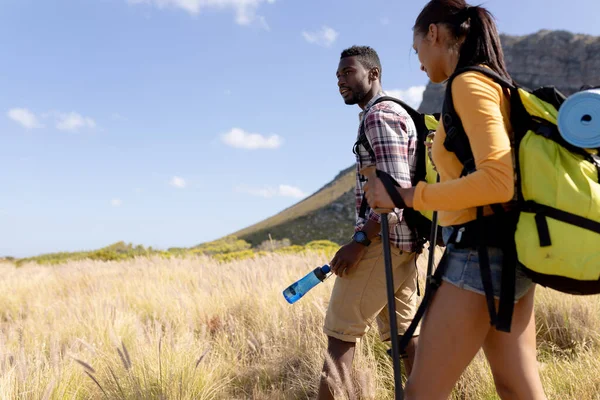 Fit African American Couple Wearing Backpacks Nordic Walking Poles Mountain — Stock fotografie