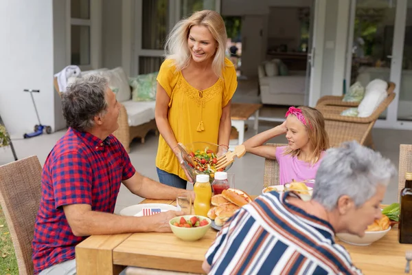 Smiling Caucasian Woman Serving Family Eating Meal Together Garden Three — Stock Photo, Image