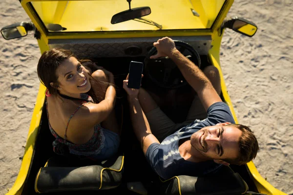 Happy Caucasian Couple Sitting Beach Buggy Sea Using Smartphone Beach — Stock Photo, Image