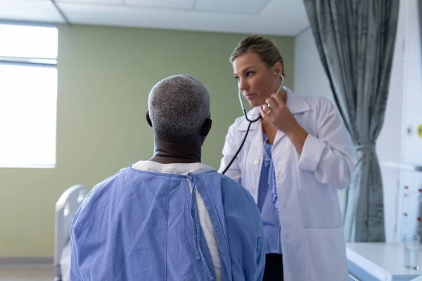 Caucasian Female Doctor Examining Stethoscope African American Male Patient Hospital — Stock Photo, Image