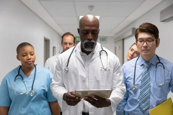 Diverse Group Male Female Doctors Walking Corridor Looking Tablet Medicine — Photo