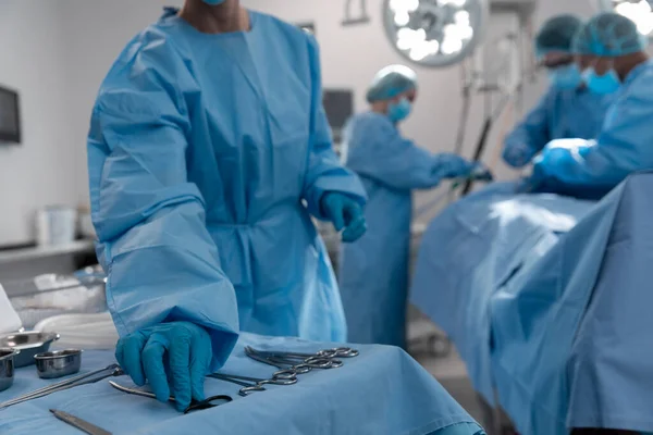 Midsection Female Surgeon Reaching Surgical Scissors Operating Theatre Medicine Health — Stock Photo, Image