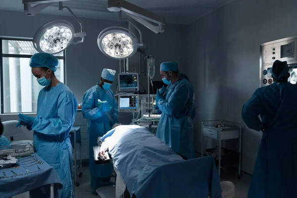 Zróżnicowani Lekarze Maskach Kombinezonach Chirurgicznych Sali Operacyjnej Medycyna Zdrowie Opieka — Zdjęcie stockowe