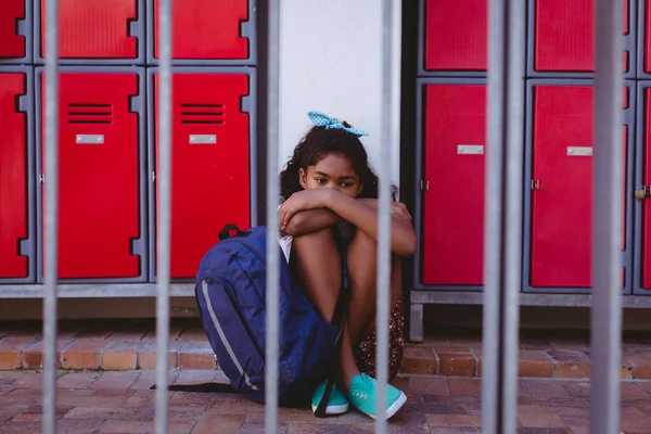 Unhappy African American Schoolgirl Sitting Lockers School Corridor Schoolbag Childhood — Stock Photo, Image