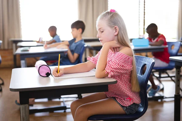 Chica Caucásica Estudiando Mientras Está Sentada Escritorio Clase Escuela Escuela — Foto de Stock