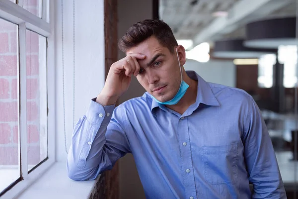 Portrait Concerned Caucasian Businessman Lowered Face Mask Leaning Windowsill Working — Stock Photo, Image