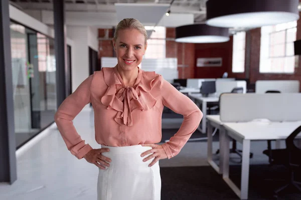 Portrait Smiling Caucasian Businesswoman Standing Office Hands Hips Looking Camera — Stock Photo, Image