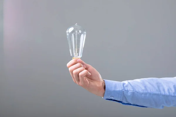 Midsection Caucasian Businessman Holding Light Bulb Isolated Grey Background Business — Stock Photo, Image