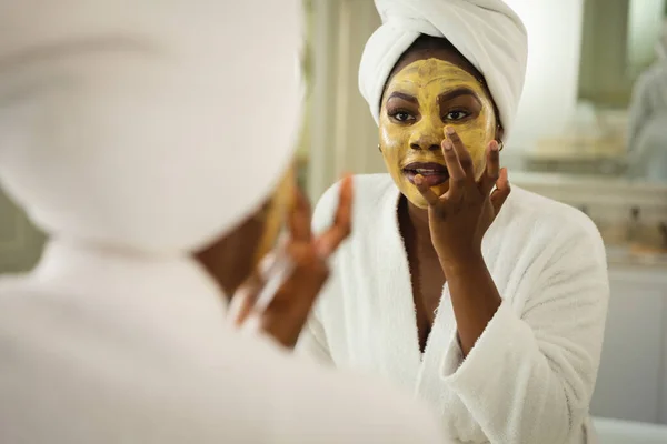 Afrikansk Amerikansk Kvinna Badrummet Bär Handduk Huvudet Tittar Spegeln Och — Stockfoto