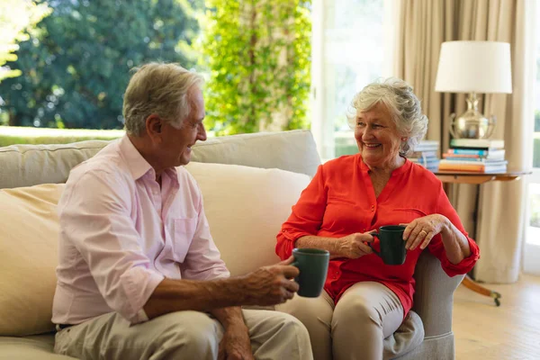 Senior Caucasian Couple Sitting Sofa Together Drinking Coffee Living Room — Stock Photo, Image