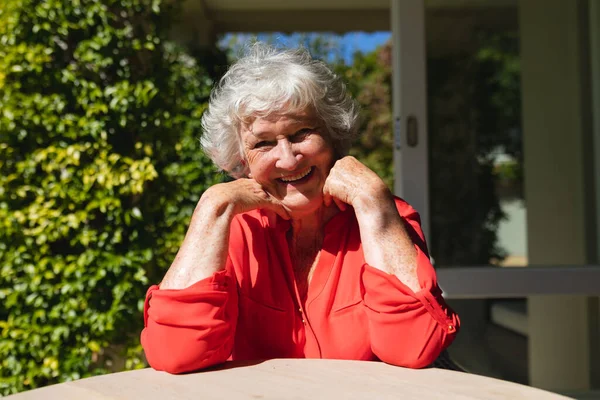 Portrait Senior Caucasian Woman Sitting Table Looking Camera Smiling Sunny — 스톡 사진