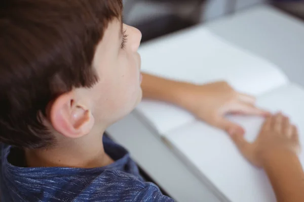 Blind Caucasian Schoolboy Sitting Desk Reading Braille Book Fingers Childhood — Stock Photo, Image