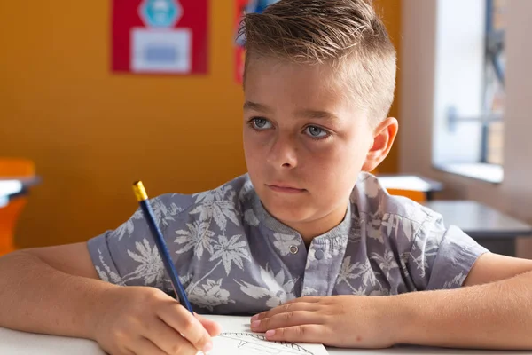 Caucasian Schoolboy Sitting Desk Classroom Writing Book Lesson Childhood Education — Stock Photo, Image