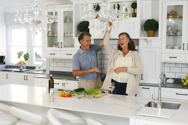 Happy Senior Caucasian Couple Modern Kitchen Dancing Together Smiling Retirement — Stock Photo, Image