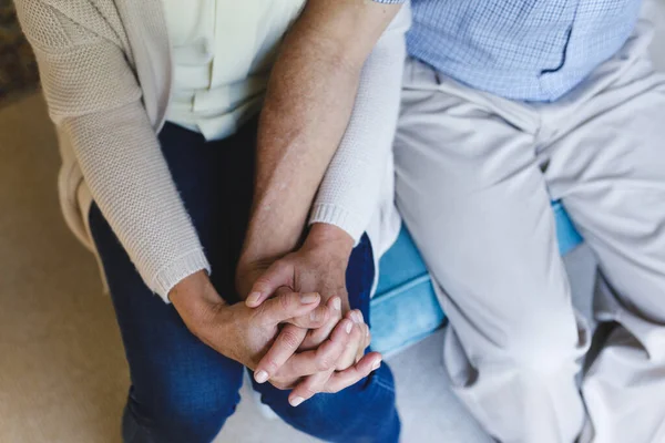 Senior Caucasian Couple Sitting Sofa Holding Hands Retirement Lifestyle Spending — Stock Photo, Image