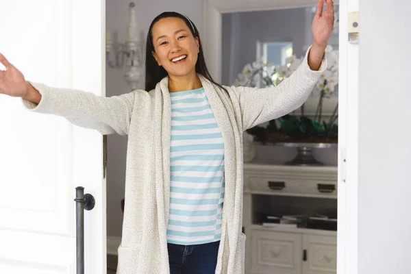 Portrait Smiling Asian Woman Arms Wide Greeting Visitor Door — Stock Photo, Image