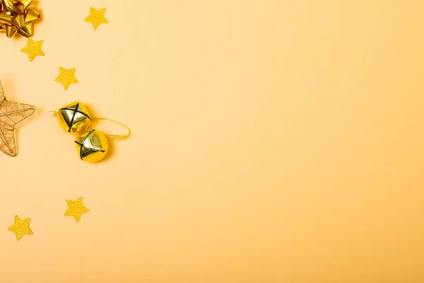Kompozycja Świątecznych Dekoracji Dzwonkami Gwiazdami Przestrzenią Kopiowania Żółtym Tle Boże — Zdjęcie stockowe