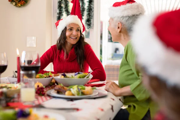 Happy Caucasian Adult Daughter Senior Mother Wearing Santa Hats Talking — Stock Photo, Image