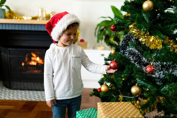 Happy Caucasian Boy Wearing Santa Hat Decorating Christmas Tree Christmas — Stock Photo, Image