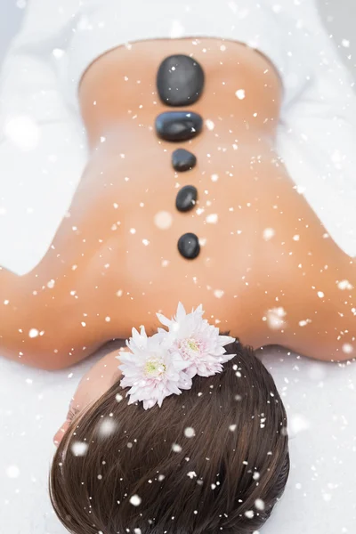 Beautiful woman receiving stone massage — Stock Photo, Image