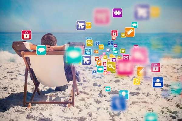 Businessman relaxing on his sun lounger — Stock Photo, Image