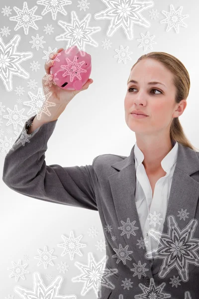 Bank employee taking close look at piggy bank — Stock Photo, Image