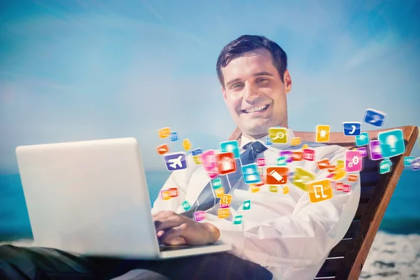 Businessman lying with his computer — Stock Photo, Image