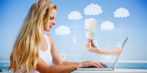 Blonde using her laptop at the beach — Stock Photo, Image