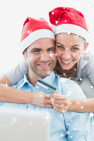 Couple in santa hats shopping online — Stock Photo, Image