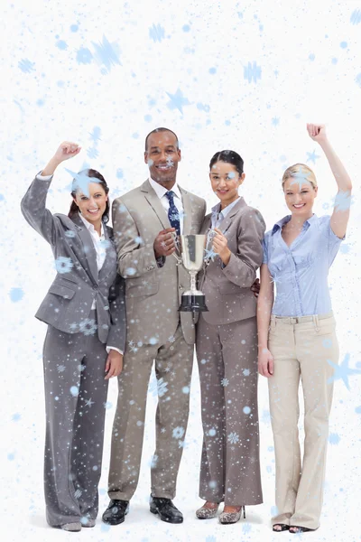 Happy business team holding a cup — Stock Photo, Image