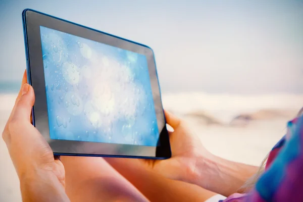 Tablet showing blue water drop pattern — Stock Photo, Image