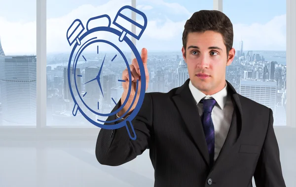 Businessman standing and pointing to clock — Stock Photo, Image