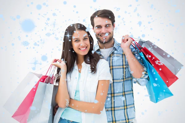 Atractiva pareja joven con bolsas de compras — Foto de Stock