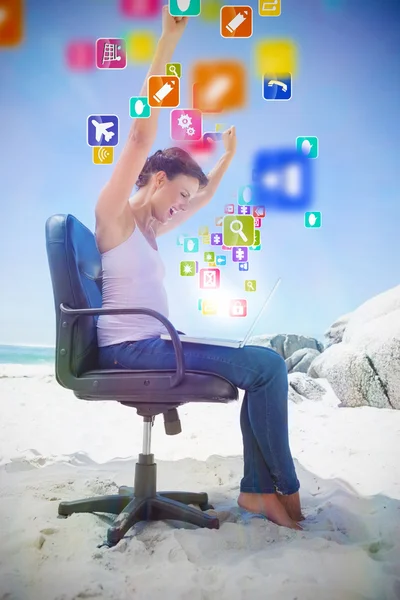 Brunette using laptop on beach — Stock Photo, Image