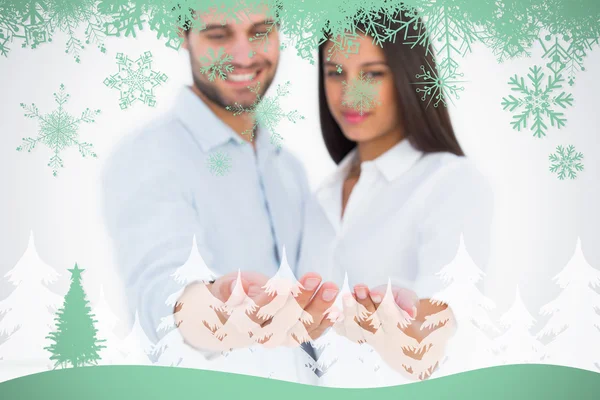 Attractive young couple holding their hands out — Stock Photo, Image