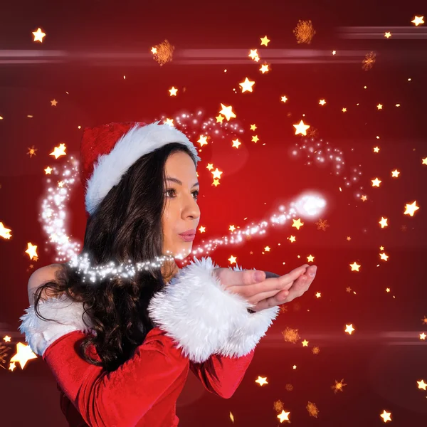 Pretty girl in santa outfit blowing — Stock Photo, Image