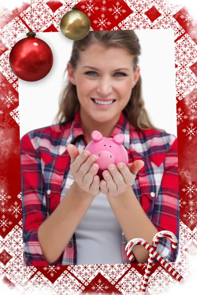 Portrait of a woman holding a piggy bank — Stock Photo, Image