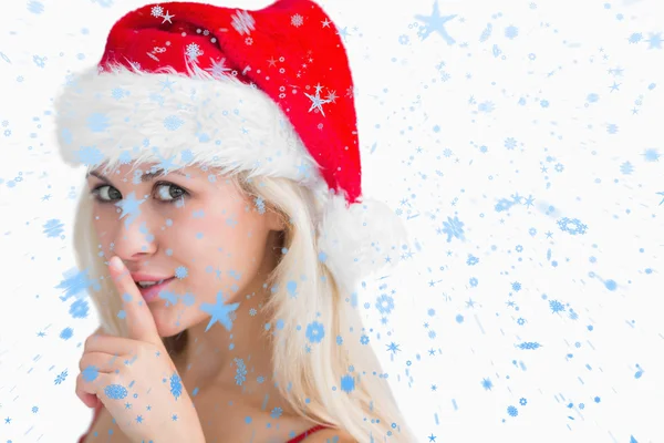 Imagen compuesta de mujer en sombrero de santa haciendo gesto de silencio — Foto de Stock