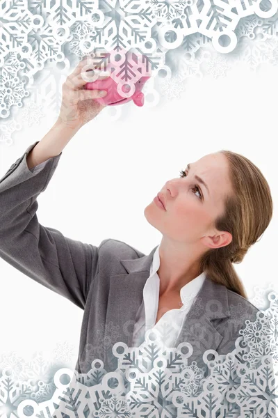 Bank employee looking at piggy bank — Stock Photo, Image