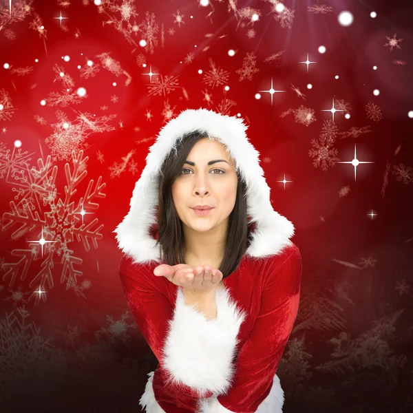 Pretty girl in santa outfit blowing Stock Picture