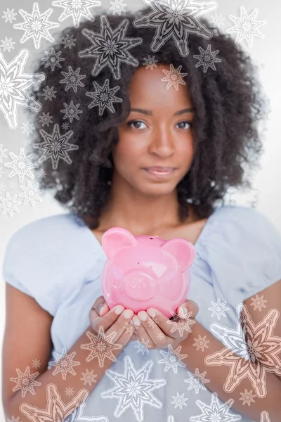 Mulher segurando um porquinho rosa banco perto — Fotografia de Stock