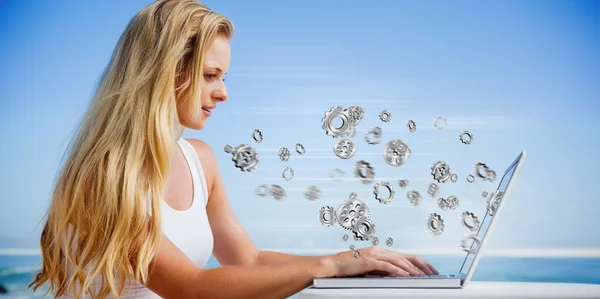 Blonde using her laptop at the beach — Stock Photo, Image