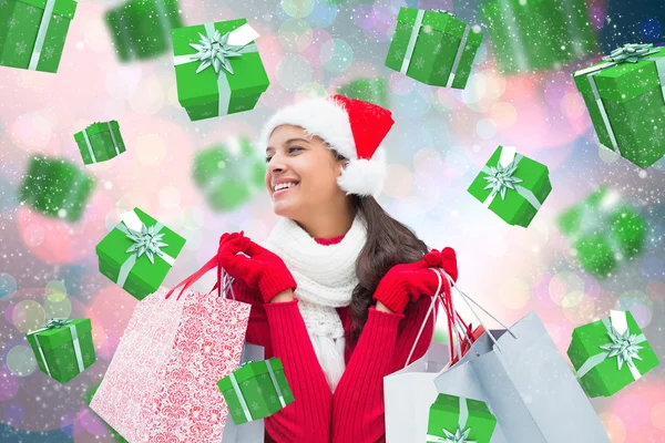 Imagem composta de morena festiva segurando sacos de compras — Fotografia de Stock
